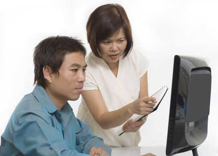 Businesswoman and man looking at computer with selective focus on womanの写真素材