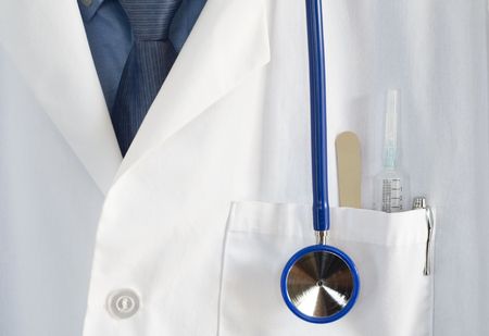 close up of Doctors coat with stethoscope,pen,syringe,and tongue depressorの写真素材