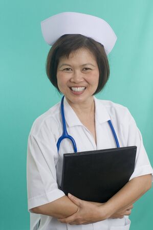 Nurse standing with green backgroundの写真素材