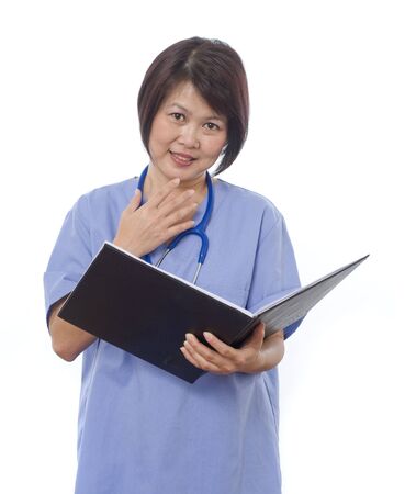 Attractive Asian medical professional with patients recordsの写真素材