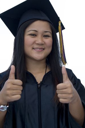Young woman with graduation cap and gown の写真素材