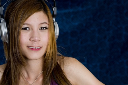 Sexy young girl listening to music on headphonesの写真素材