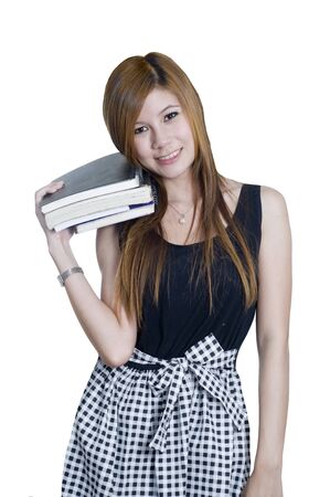 Young attractive female Asian student holding her school booksの写真素材