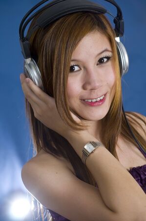 Long haired young girl listening to music on headphonesの写真素材