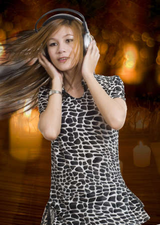 Sexy young girl listening to music on headphonesの写真素材