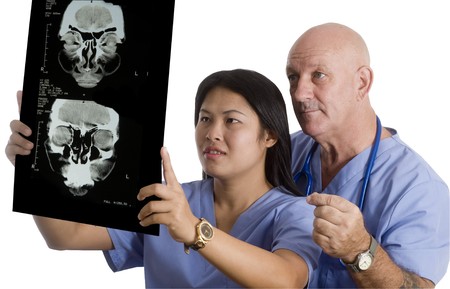 Doctor and Nurse standing with white background looking at X-Rayの写真素材