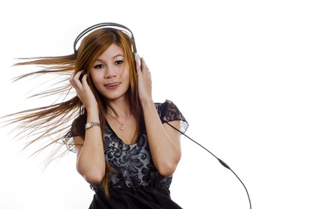 Sexy young girl listening to music on headphonesの写真素材
