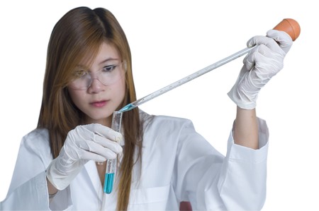 Researcher pouring chemicals in a laboratoryの写真素材
