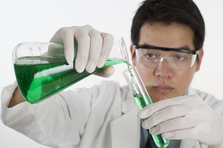 Scientist pouring chemicals in a laboratoryの写真素材