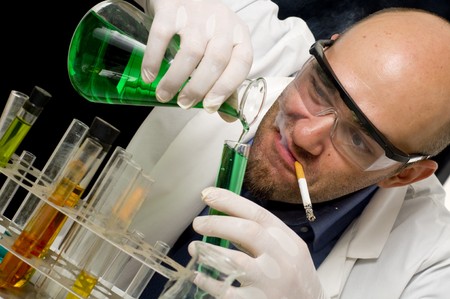 Crazy mad Scientist pouring chemicals in a laboratoryの写真素材