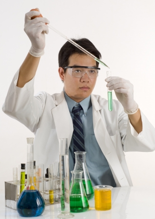 Scientist pouring chemicals in a laboratoryの写真素材