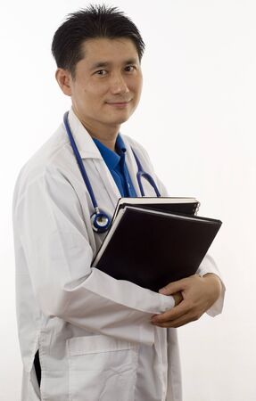 Doctor holding patients records and isolated on whiteの写真素材