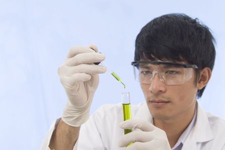 Student Scientist pouring chemicals in a laboratoryの写真素材