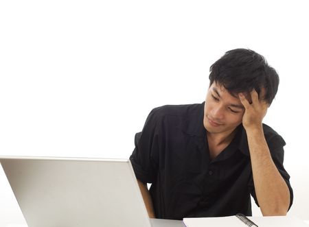 Asian teenage student holding his head and thinkingの写真素材