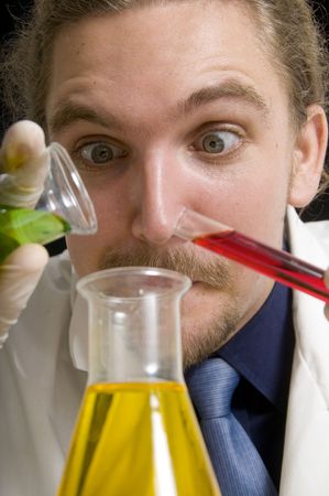 Scientist pouring chemicals in a laboratoryの写真素材