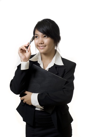 Portrait of a young attractive Asian business woman thinkingの写真素材