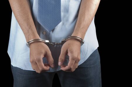 Handcuffs on a man who is arrestedの写真素材
