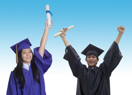 Two Asian students with graduation cap and gown and diploma の写真素材