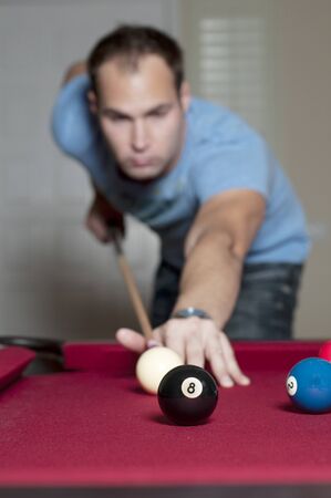 Young man playing a game of pool