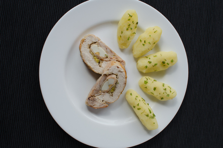 Chicken roulade with herb potatoesの写真素材