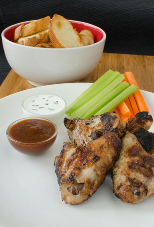 Grilled Chicken wings with dipcelery and carrotsの写真素材