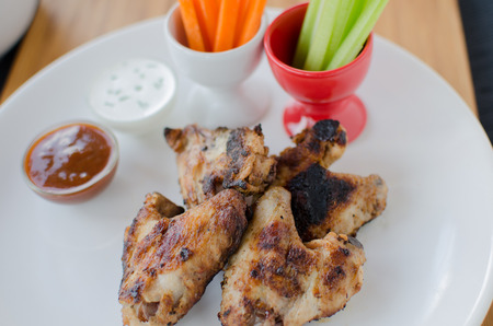 Grilled Chicken wings with dipcelery and carrotsの写真素材