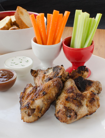 Grilled Chicken wings with dipcelery and carrotsの写真素材