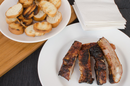 Spareribs on grill with dip, toasted baguetteの写真素材