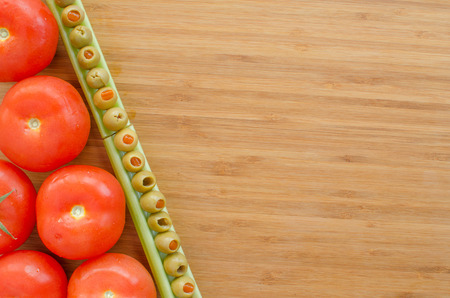 Vegetables on cutting board, background, olive and celeryの写真素材