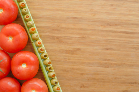 Vegetables on cutting board, background, olive and celeryの写真素材