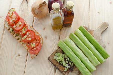 grilled baguette with grilled tomatoes, olive oil and cutted celeryの写真素材