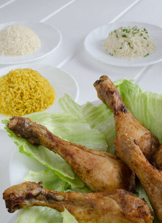 Grilled chicken thighs with with three rice on white woodの写真素材