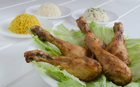 Grilled chicken thighs with with three rice on white woodの写真素材