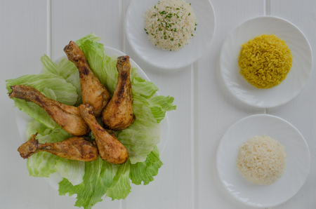 Grilled chicken thighs with with three rice on white woodの写真素材