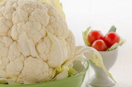 Cauliflower fresch with little tomatoes in green dishの写真素材