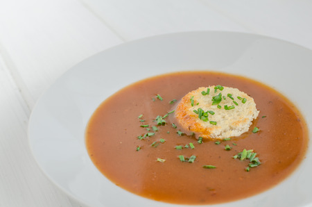 Goulash soup with fresh herbs and toastの写真素材