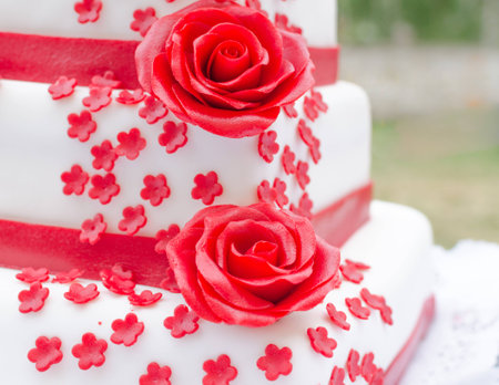 wedding cake with bow and roseの写真素材