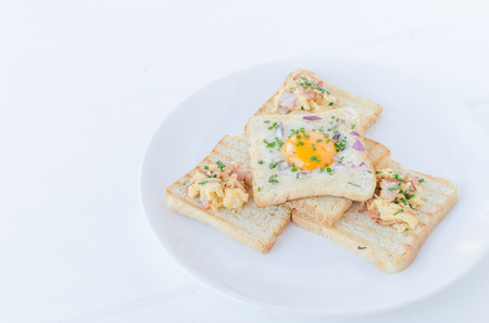 Fried egg inside toast with chive, ham and scrambled eggsの写真素材
