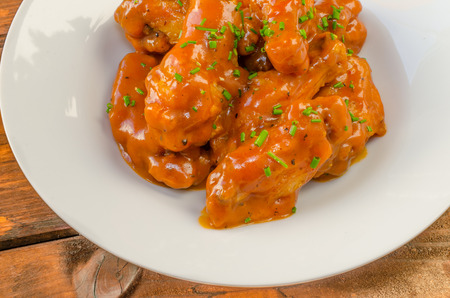 Buffalo chicken hot wings with mayonnaise sauce and celeryの写真素材