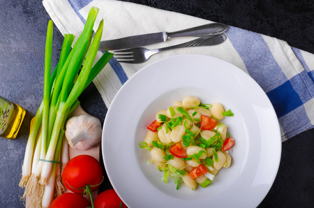 Vegetarian gnocchi with spring onions and tomatoes, herbs, olive oil and garlicの写真素材