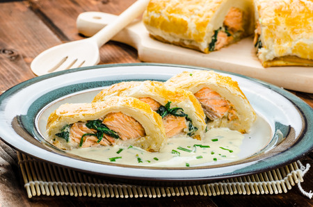 Salmon baked in puff pastry with spinach and garlicの写真素材