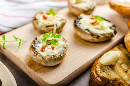 Grilled mushrooms stuffed with blue cheese and chilli and garlic toastの写真素材