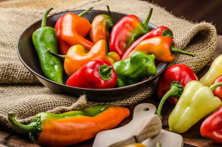 Slicing peppers with wood knife on wood board