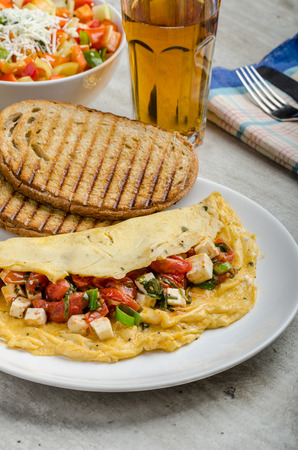 Mediterranean-Style Omlette with crispy garlic bread and apple juice, feta cheese, spring onion fillingの写真素材