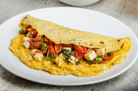Mediterranean-Style Omlette with crispy garlic bread and apple juice, feta cheese, spring onion...
