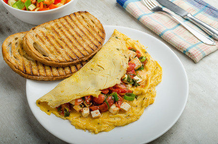 Mediterranean-Style Omlette with crispy garlic bread and apple juice, feta cheese, spring onion fillingの写真素材