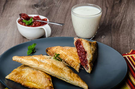 Red currant cheesecake-puzzle with mint and fresh milkの写真素材