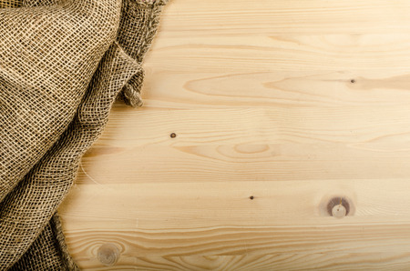 Sacking on wood background, advertisment place, sack