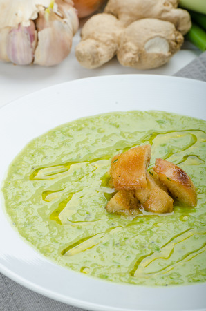 Soup of young peas, homemade crispy croutons and teaの写真素材