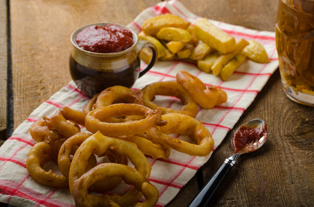 Onion rings, hot dip, french fries and Czech beer, all homemade, all original.の写真素材